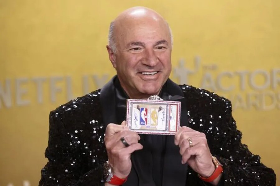 Kevin O'Leary holding the Jordan/Kobe dual logoman card